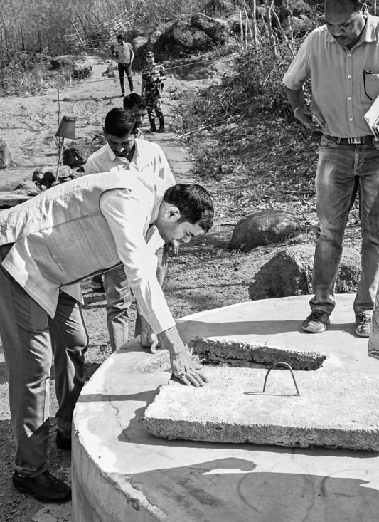 Optimizing traditional drinking water sources for accelerating change - Deputy Commissioner Ravi Shankar Shukla inspecting the innovative spring-based sanitary well in Paharia Tola, village Jhajhapara, district Dumka, Jharkhand